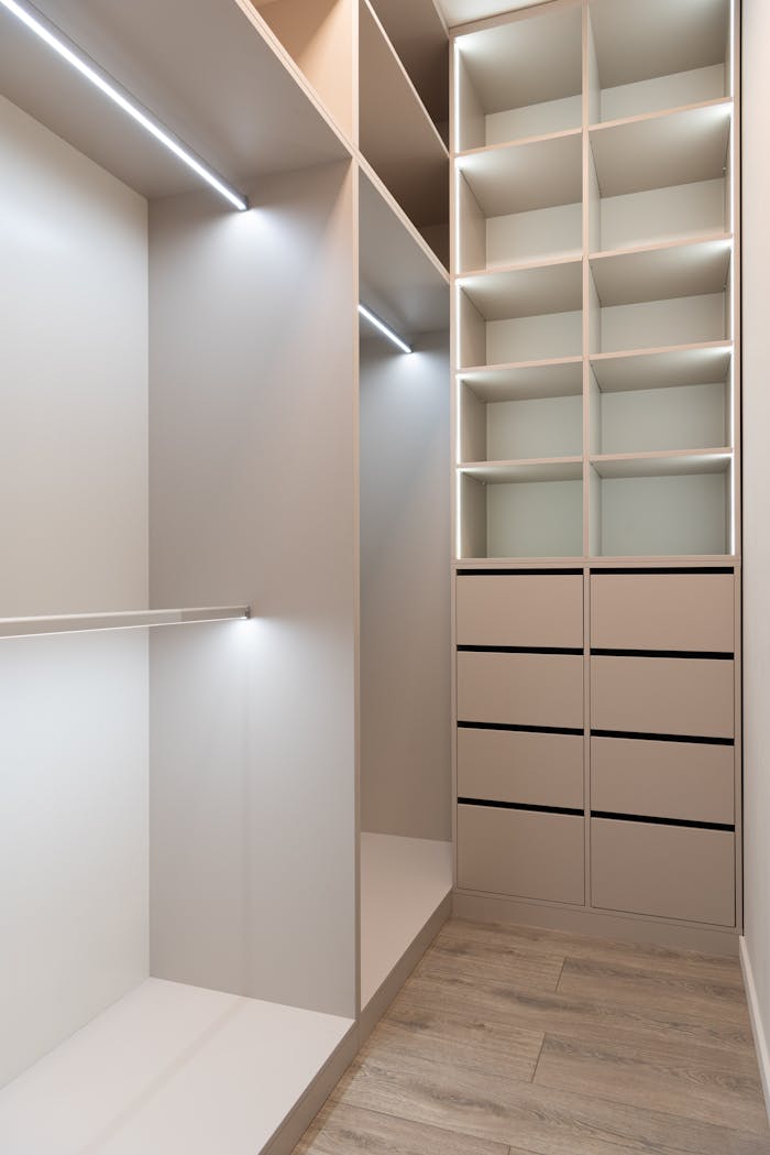 Elegant and spacious modern walk-in closet with ample storage and minimalist design.